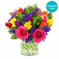 Bright bunch of mixed blooms with glass vase