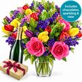 Celebration package with bright mixed bunch, sparkling, chocolates and vase