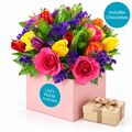 Colourful mixed flowers with a box of chocolates