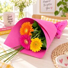 3 bright mixed gerberas wrapped and presented as a bunch