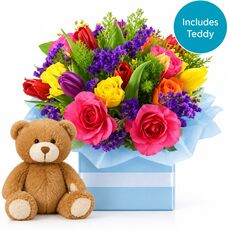 Beautiful fresh mixed flowers set in a box with a teddy for a boy