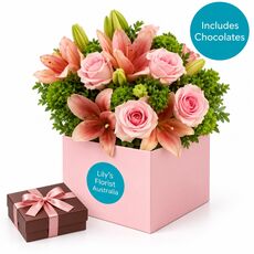 Blush pink fresh blooms set in a box with yummy chocolates
