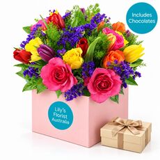 Colourful mixed flowers with a box of chocolates