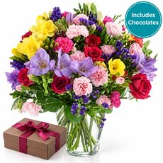 Large bunch of mixed colourful blooms with a box of yummy chocolates
