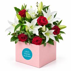 Lilies and fresh roses set in a boxed arrangement