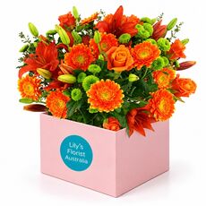 Gorgeous mixed orange blooms set in a boxed arrangement