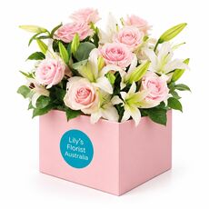 Peerfect combination of pastel pink lilies and roses in a box