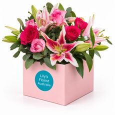 Pink lilies and roses set in a pretty box