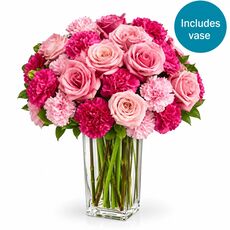 Roses and carnations set in a beautiful glass vase