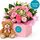 Pink flowers for a baby girl in a box with a teddy bear