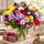 Big colourful bunch of fresh blooms with a box of chocolates
