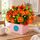 Mixed orange flowers set in to a lovely box