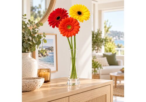 3 wrapped gerberas in a lovely glass vase