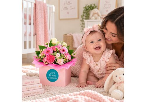 pink flowers in a box to celebrate the arrival of a new baby girl