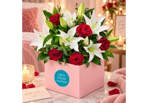 red roses and white lilies in a box